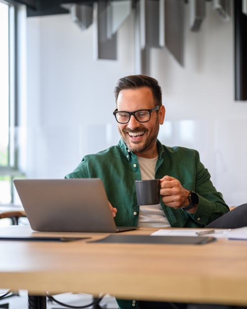 Man Smiling at Computer